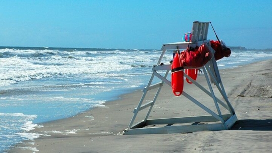 Empty lifeguard's chair on a beach.