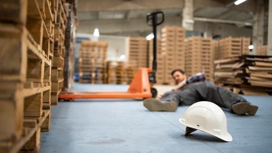 Warehouse worker who slipped and fell on the floor.
