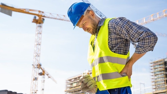 Worker at a worksite having some back issues.